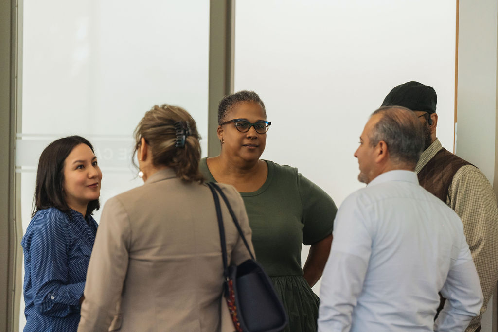 Community members networking at WE RISE 2025