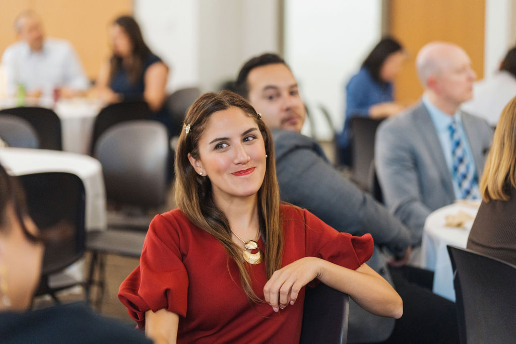 Guest smiling during the WE RISE 2025 program
