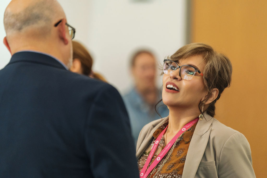 Attendees greeting each other before the program
