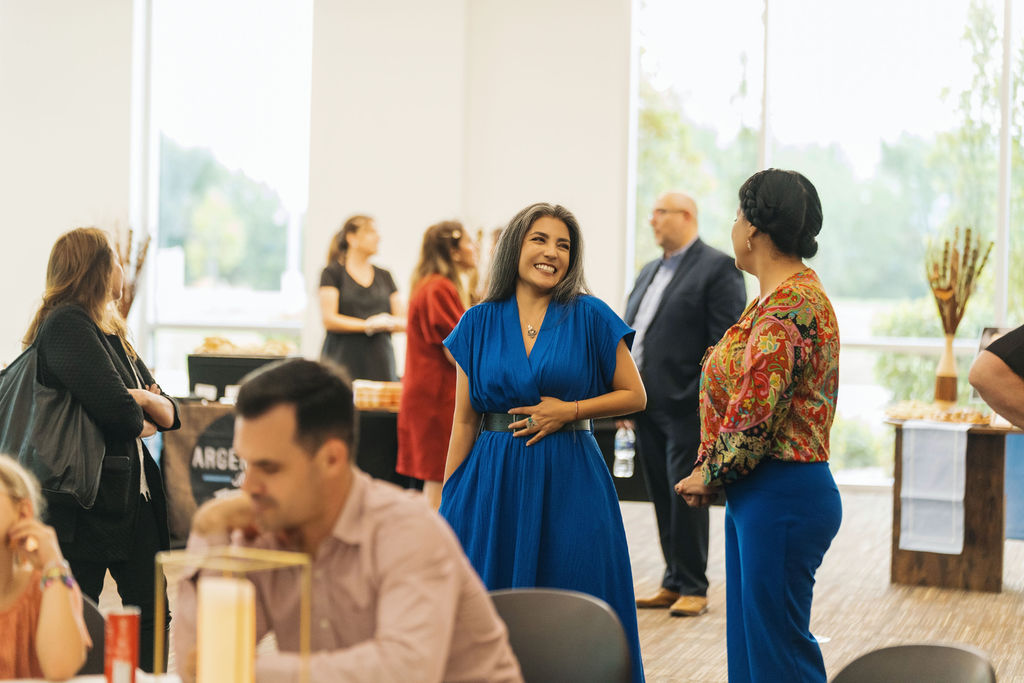 Attendees laughing together during the reception