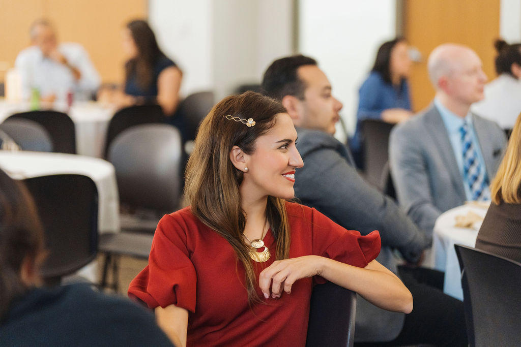 Attendee listening to the program at WE RISE 2025