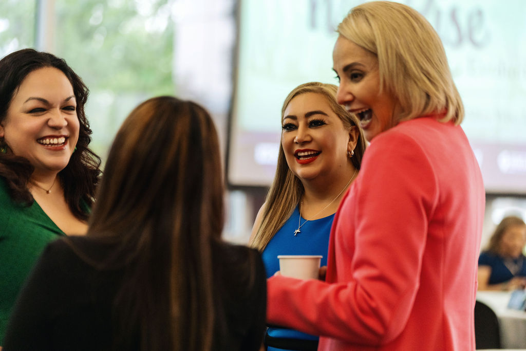 Group of women sharing a laugh at WE RISE 2025